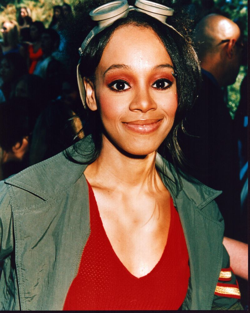 Lisa Lopes vibrant photo print in green jacket and red top