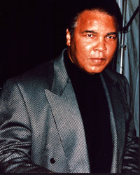Muhammad Ali photo print in gray blazer and black shirt, capturing the essence of the boxing legend.