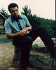 Muhammad Ali sitting on rock photo print, iconic sports image.