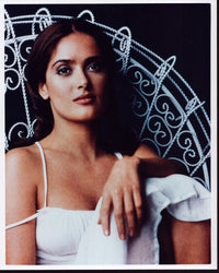 Salma Hayek sitting in a white metal chair photo print