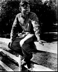 Clark Gable sitting on a fence in It Happened One Night black and white photo print.