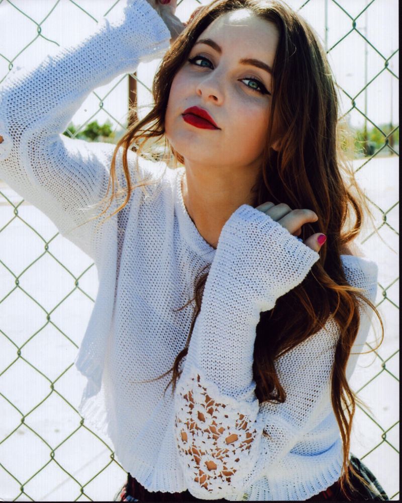 Alexa Losey leaning on fence in white sweater photo print.
