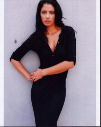Jessica Clark leaning on wall in black top photo print.
