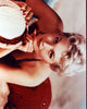 Kim Novak lounging in red swimsuit with hat photo print.