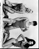 Baywatch black and white photo print featuring Pamela Anderson, Alexandra Paul, and Yasmine Bleeth posed on knees.