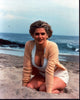 Kristy Swanson sitting in sand photo print, available in multiple sizes.