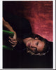 Taylor Kitsch sitting backwards in a green chair photo print.