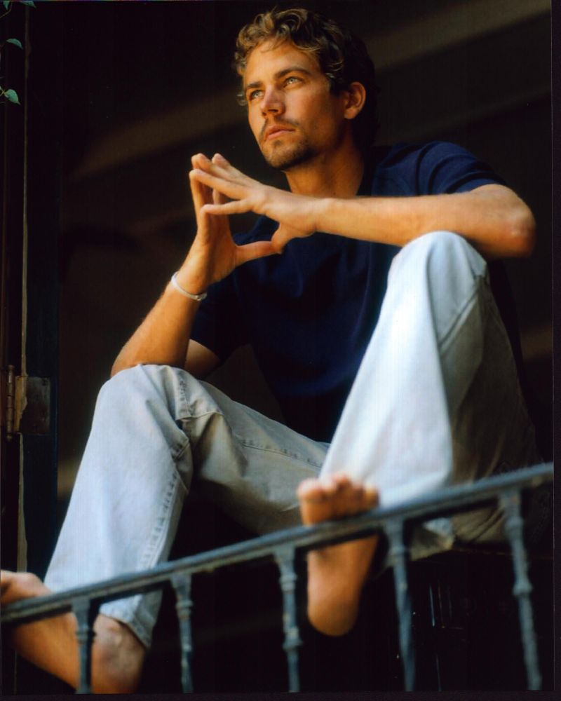 Paul Walker photo print with feet on railing, perfect for fans.