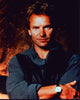 Sting photo print wearing sweatshirt and leather vest.