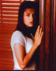 Neve Campbell leaning on wall photo print, capturing elegance and style.