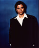 John Stamos photo print in a black jacket and white shirt, stylish celebrity portrait.
