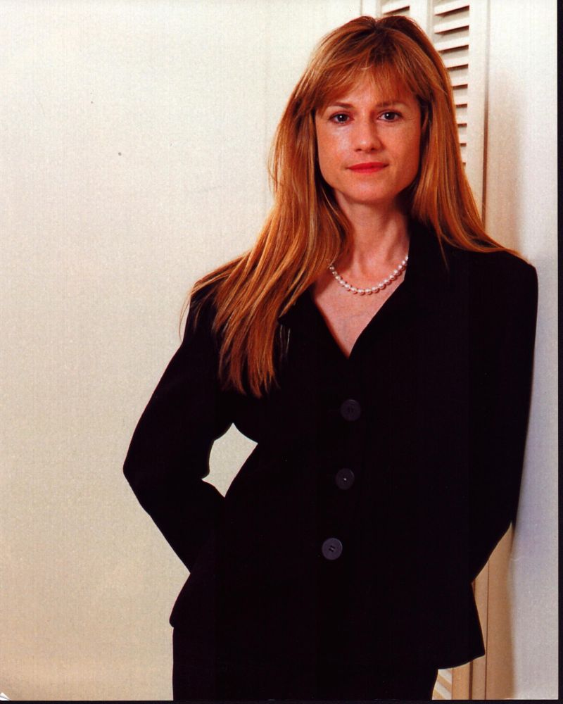 Holly Hunter photo print in black suit leaning on wall.