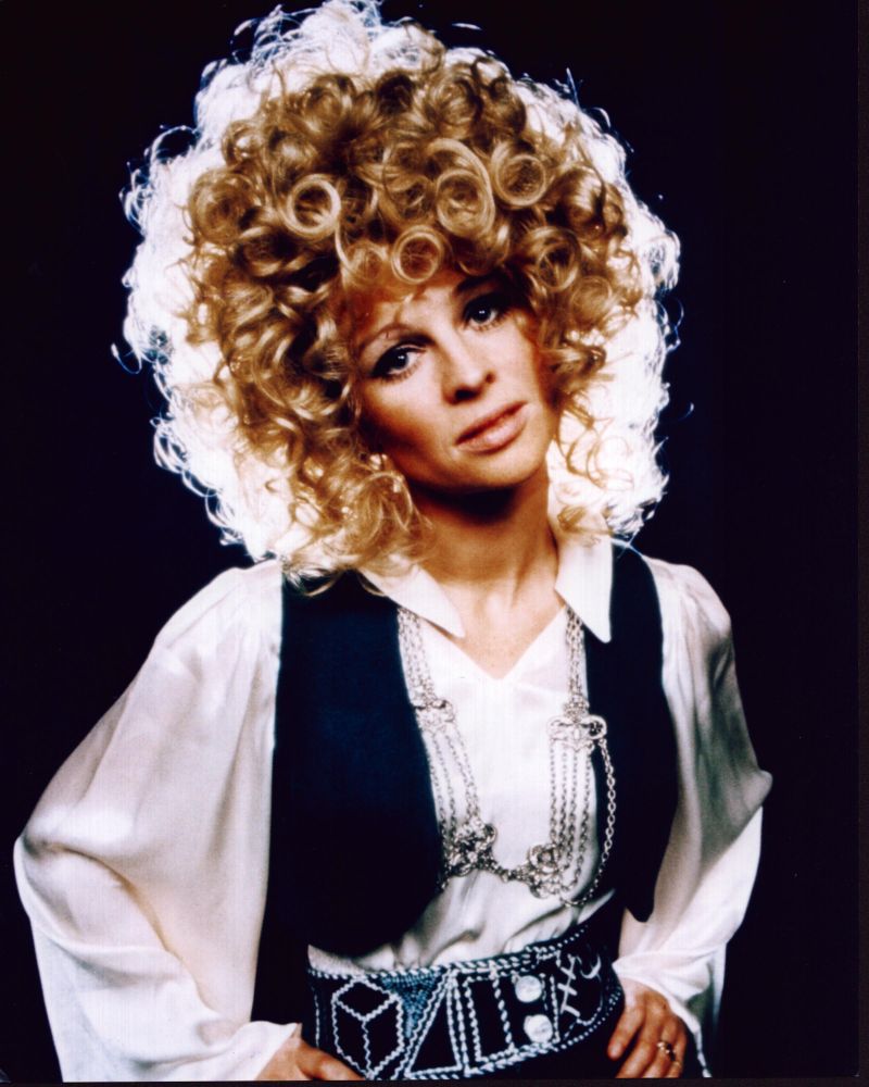 Julie Christie photo print in a black vest and silver necklaces.