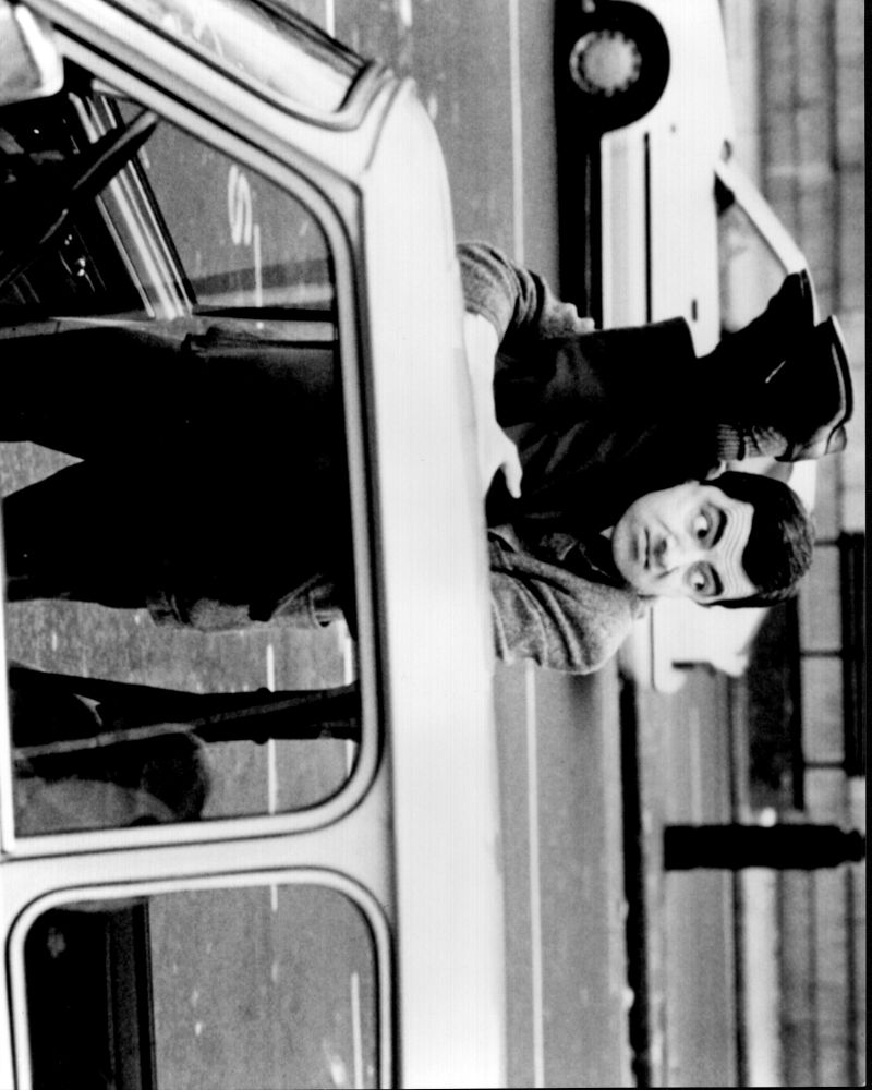 Rowan Atkinson black and white photo print with legs in bean.