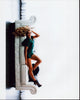Lindsay Arnold in a green romper laying on a couch photo print.