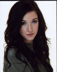 Gianna Martello headshot photo print in green jacket.