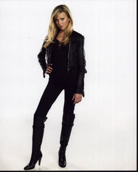 Katie Cassidy photo print in black outfit with hand on hip.