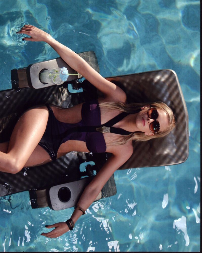Katie Cassidy relaxing on a pool float - Photo Print