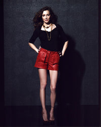 Katie Cassidy photo print in red leather shorts, vibrant and stylish.