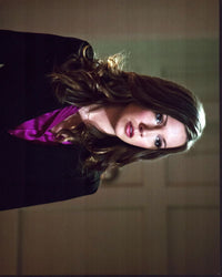Katie Cassidy wearing a black blazer and purple shirt in Arrow photo print.