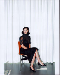Sophia Amoruso sitting in a black lace dress photo print