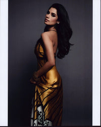 Diane Guerrero photo print looking over shoulder in gold dress.