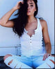 Lauren Elizabeth photo print sitting against wall in ripped jeans.