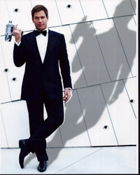 Michael Weatherly in Tuxedo holding a large silver gun photo print.