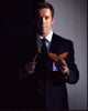 Damian Lewis posing with a cantaloupe photo print.