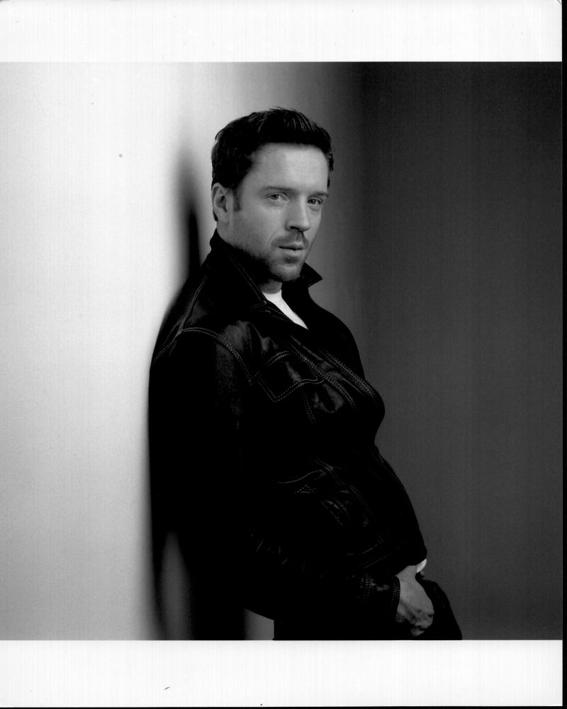 Black and white photo print of Damian Lewis leaning on wall.