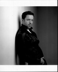 Black and white photo print of Damian Lewis leaning on wall.