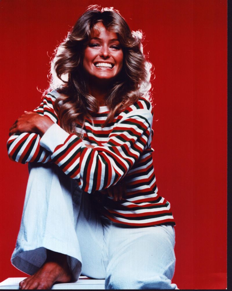 Farrah Fawcett smiling in white pants and red striped top photo print