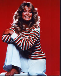 Farrah Fawcett smiling in white pants and red striped top photo print