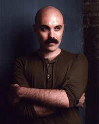 David Lowery photo print with arms crossed in a green top