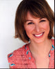 Emily Bell smiling in a pink top photo print.
