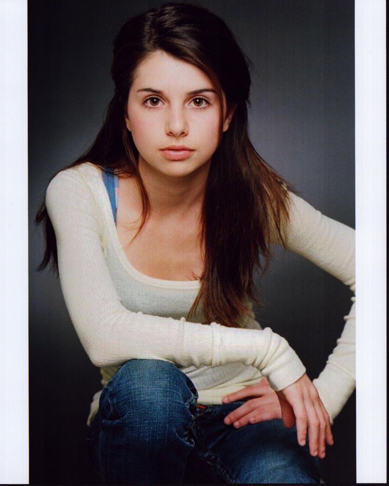Emma Lockhart in white long sleeve photo print with arm on knee