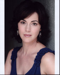 Joanna Going headshot photo print in dark blue sleeveless top.