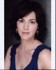 Joanna Going headshot photo print in dark blue sleeveless top.