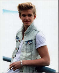Cody Simpson leaning on rail in denim vest photo print