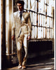 Luke Grimes photo print in a white suit in front of a window.