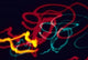 Red, Yellow and Green Neon Lighting Nightzoom Poster Print by Mark Gibson