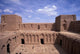 Abandoned Fortress in Morocco Poster Print by John & Lisa Merrill, showcasing stunning architecture and landscape.