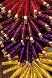 Colorful spools of thread hanging in a market in Fes, Morocco poster print.