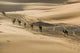 Morocco Camel Caravan Poster Print by Walter Bibikow showcasing Erg Chebbi Dunes.