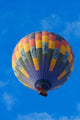 Rainbow hot air balloon soaring over Namib Desert in Namibia