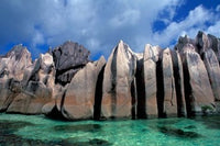 Unique rock formations on the shore of Curieuse Island, Seychelles poster print by Nik Wheeler.