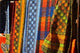 Cloth Stall at African Curio Market Poster Print by David Wall, colorful cultural scene from Cape Town.