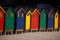 Colorful Bathing Boxes Poster Print by Stuart Westmorland showcasing vibrant beach scene.