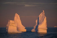 Antarctic Peninsula icebergs at midnight sunset poster print by Kevin Schafer