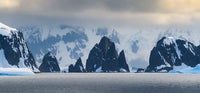 Antarctic Peninsula Poster Print showcasing craggy rocks and mountains by Yuri Choufour